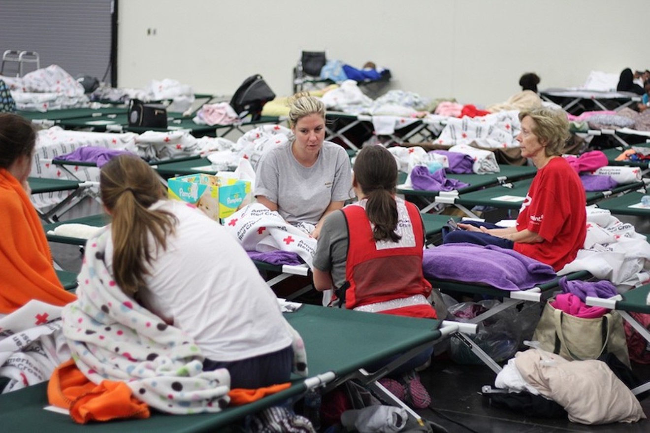 Volunteers assist people displaced by Hurricane Harvey at the George R. Brown Convention Center earlier this week.