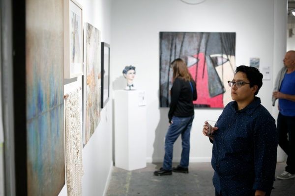 Art lovers visit Winter Street Studios to view artwork by up for auction created by some of Houston's most talented artists