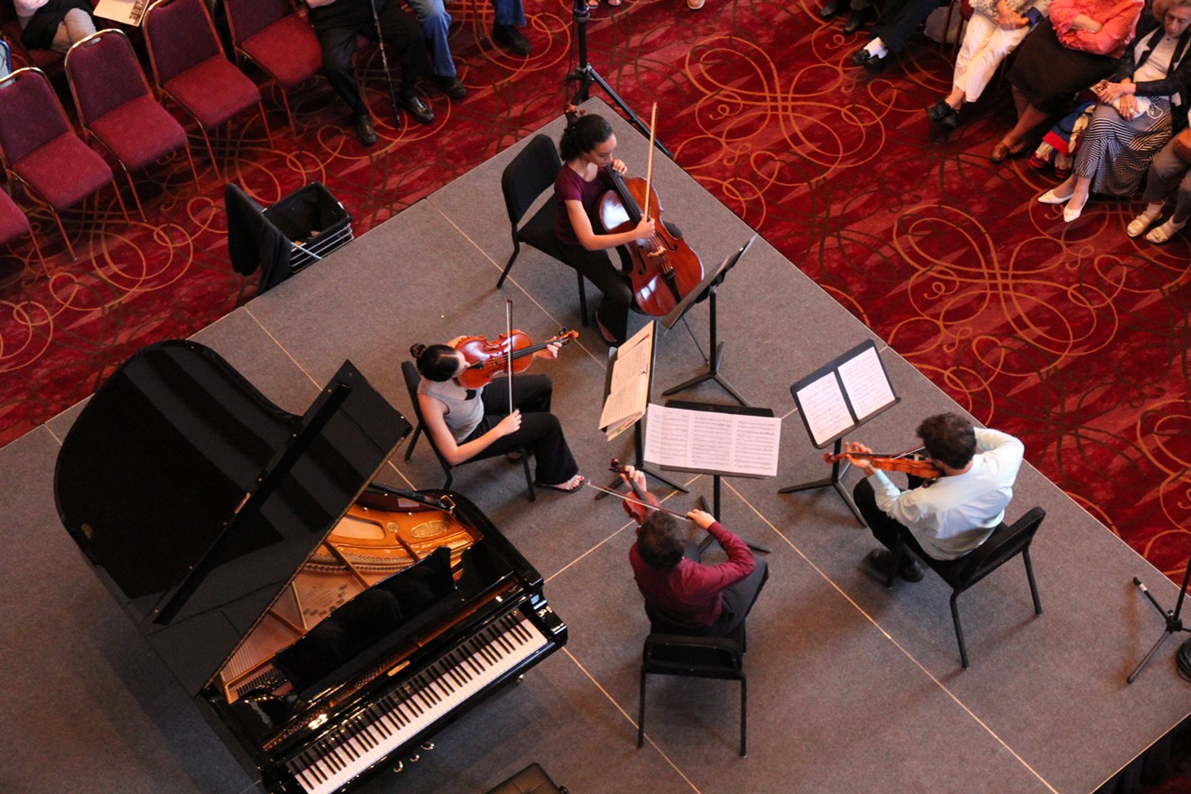 Music fills the foyer of Wortham Center as guests enjoy a free lunchtime concert.