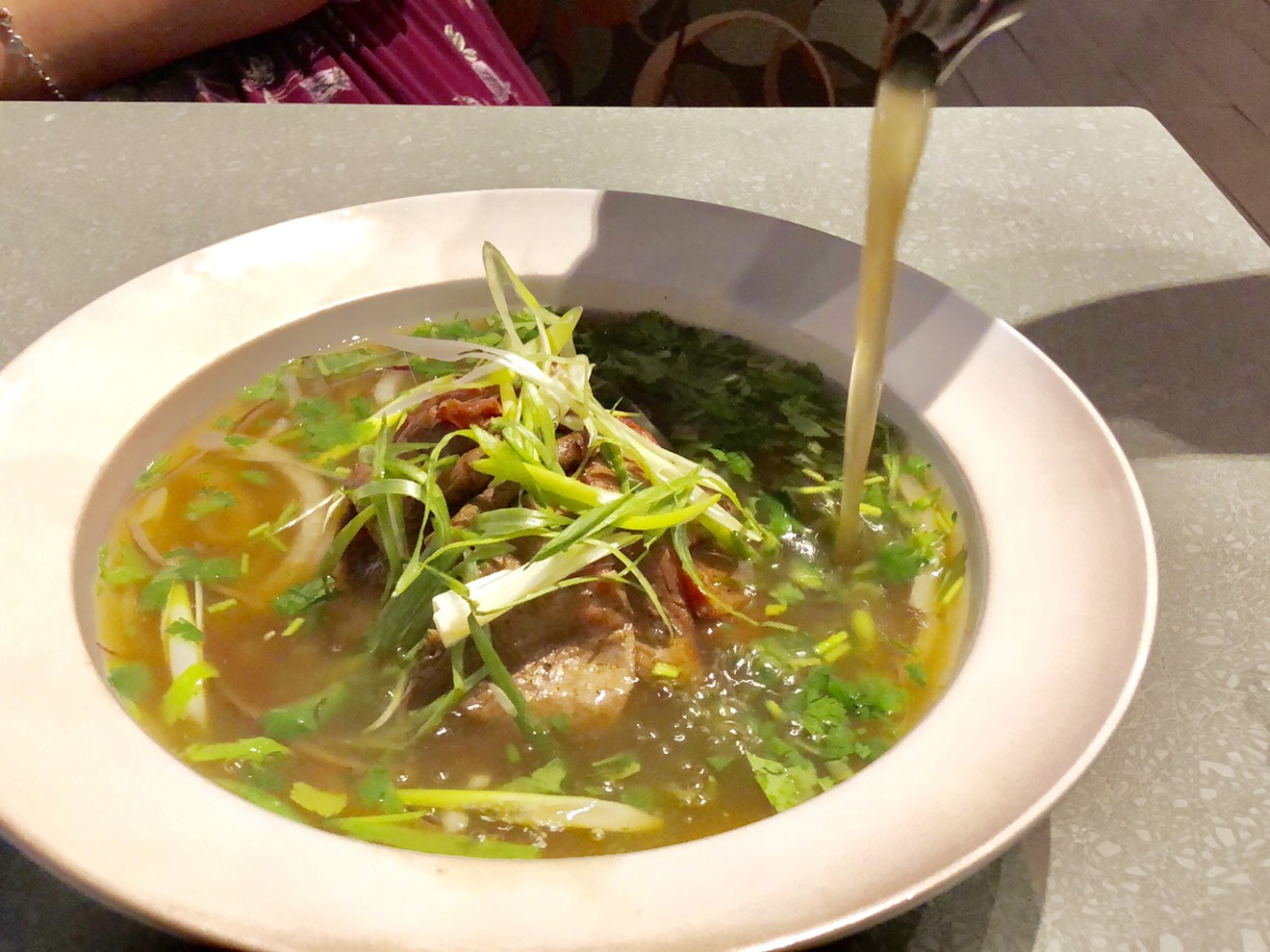 Oxtail pho is topped with thinly sliced Wagyu beef at Saigon House, taking a family recipe and making it even better.