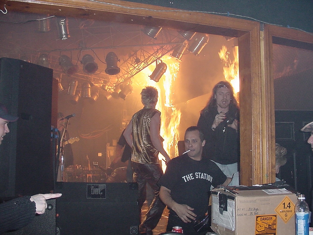 Twenty-five seconds after the first flames, fire reached the ceiling at the Station. Great White tour manager Daniel Biechele (upper right) lit the pyro effect. Note the "Danger" and "Explosive" stickers on the fireworks box.