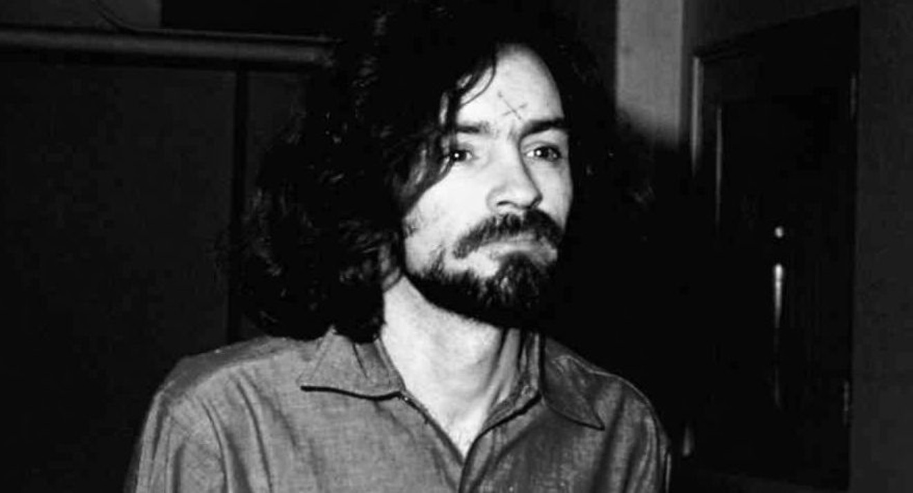 Charles Manson at the time of his trial. He had carved an "X" in his forehead to indicate he had "X'd" himself out of society. Many of his femaile followers immediately did the same. He later turned the symbol into a swastika.