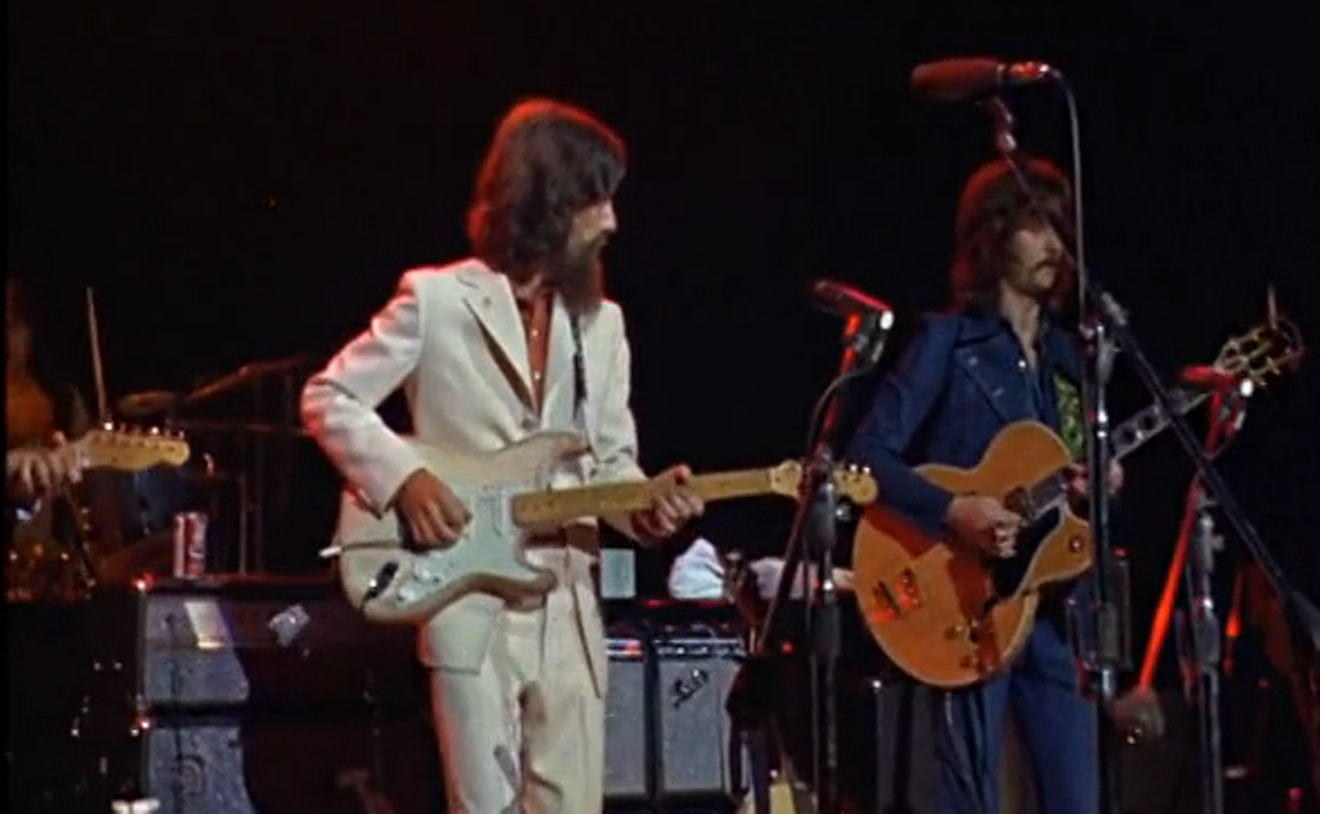 George Harrison and Eric Clapton perform together at the Concert for Bangla Desh in August 1971 at Madison Square Garden.