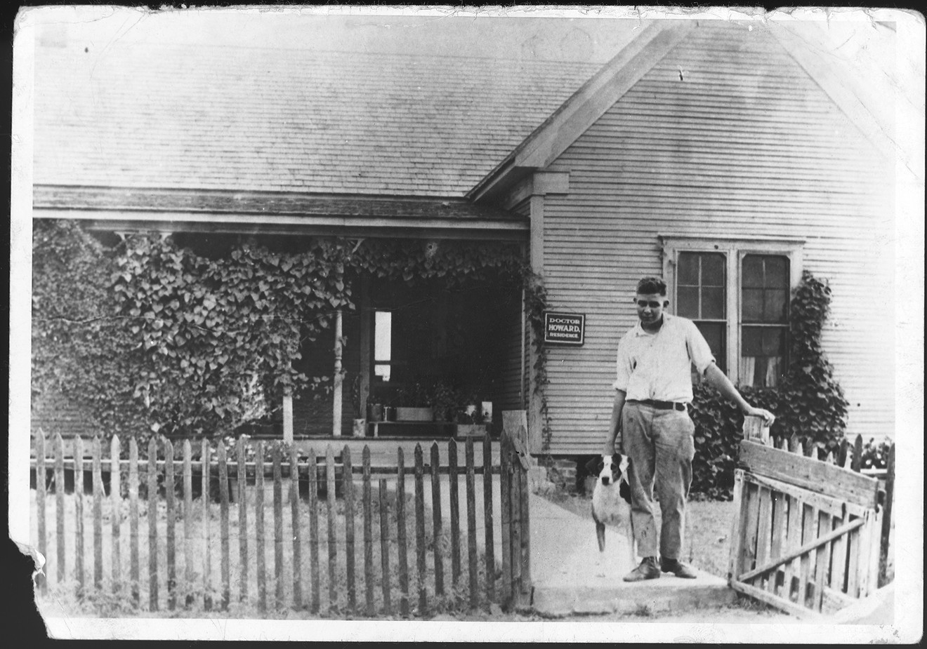 Robert E. Howard and his dog Patches in front of the Howard house, Cross Plains, Texas, (date unknown).