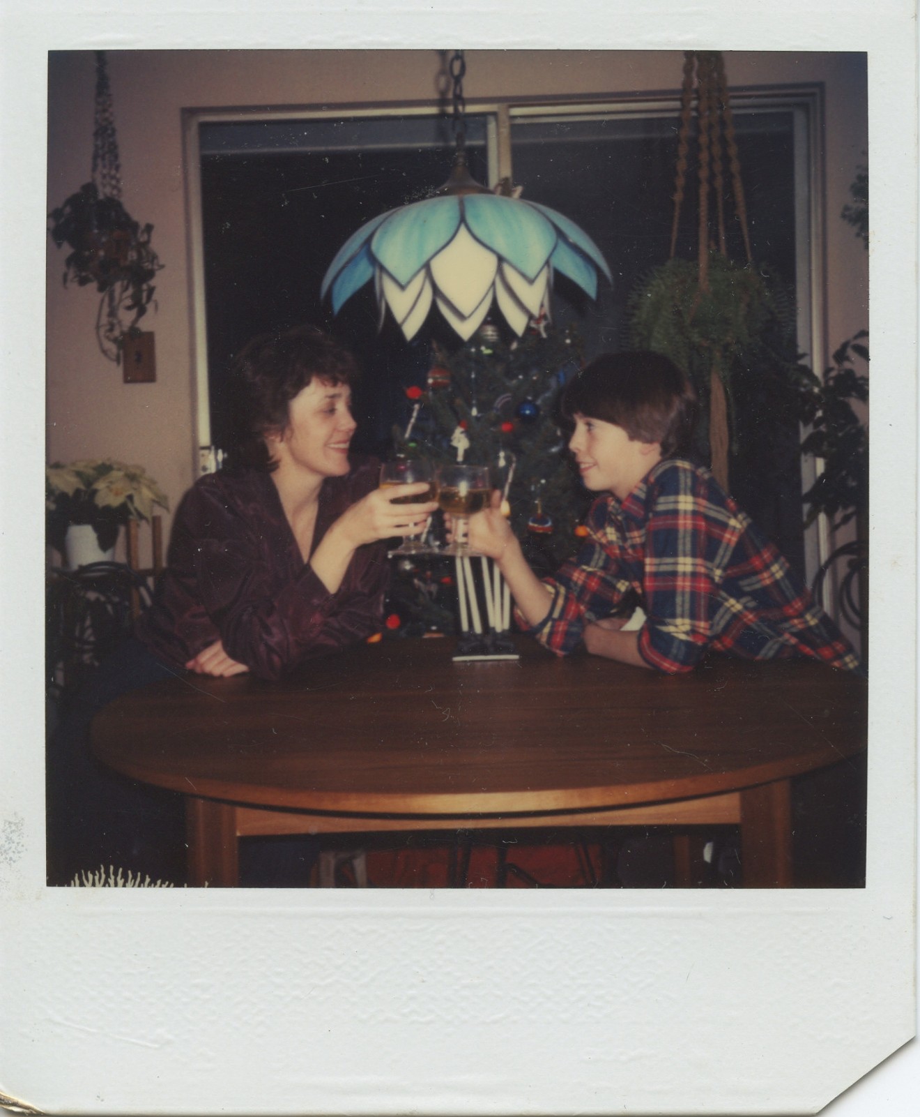 There goes his hero: Young Dave Grohl and his mom make a Christmas toast under a very '70s/'80s dining room lamp.
