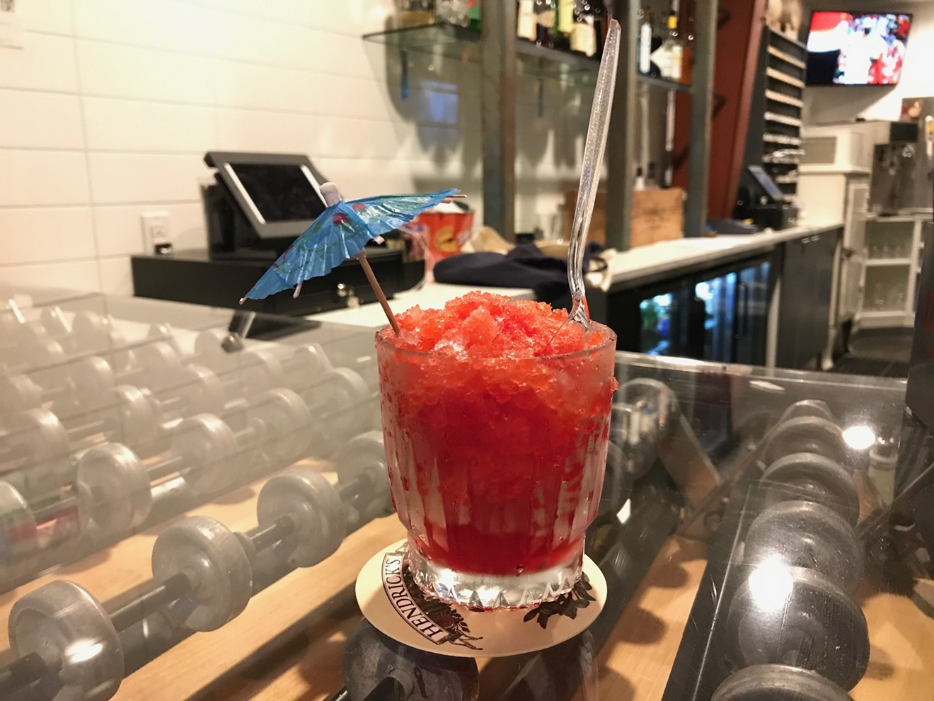 The vodka-spiked tiger's blood snowball atop a conveyer belt bar.