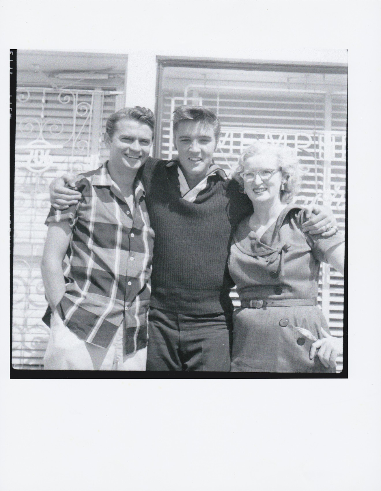 Sun Records owner Sam Phillips, Elvis Presley and Sun office manager Marion Keisker standing outside Sun at 706 Union, Memphis.