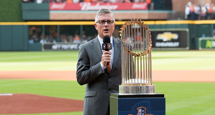 Jeff Luhnow in much happier days, standing next to the World Series trophy.