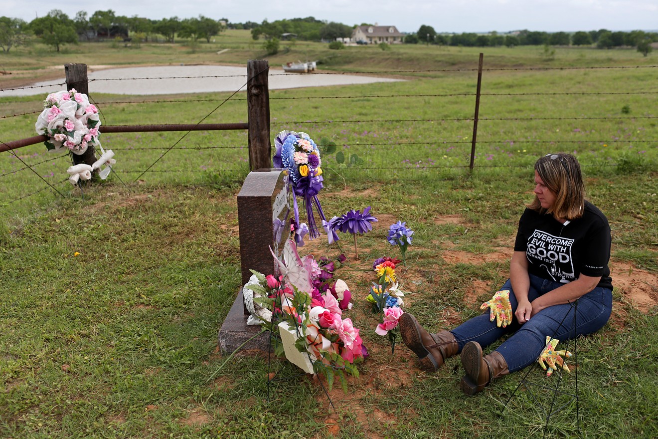 Sherri Pomeroy rests at the grave of daughter Annabelle after pulling weeds around her gravesite.