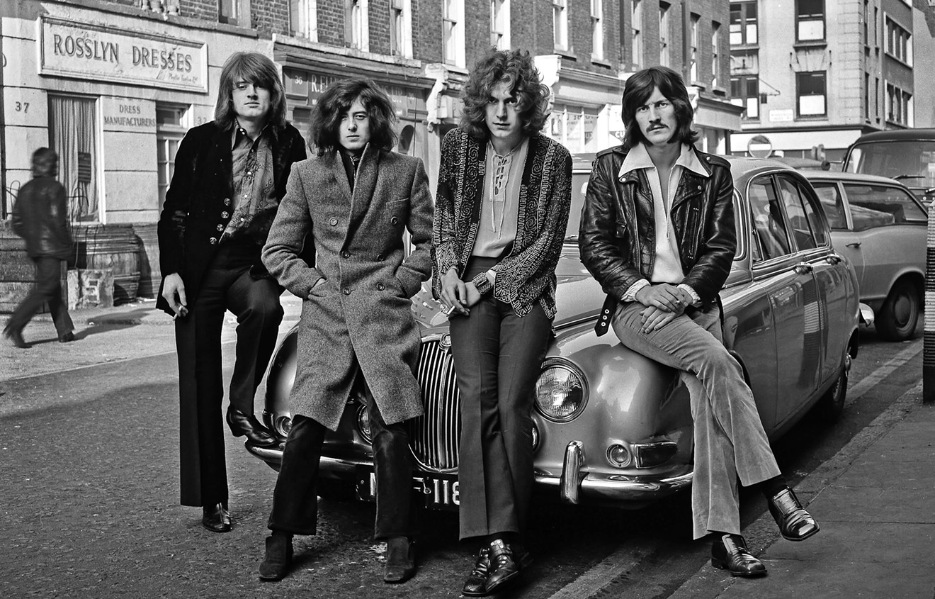 Clustered around a Jaguar Mk 2 3.8 for an early Led Zeppelin publicity photo taken outside the Impact Agency offices on Windmill Street, London, December 1968.