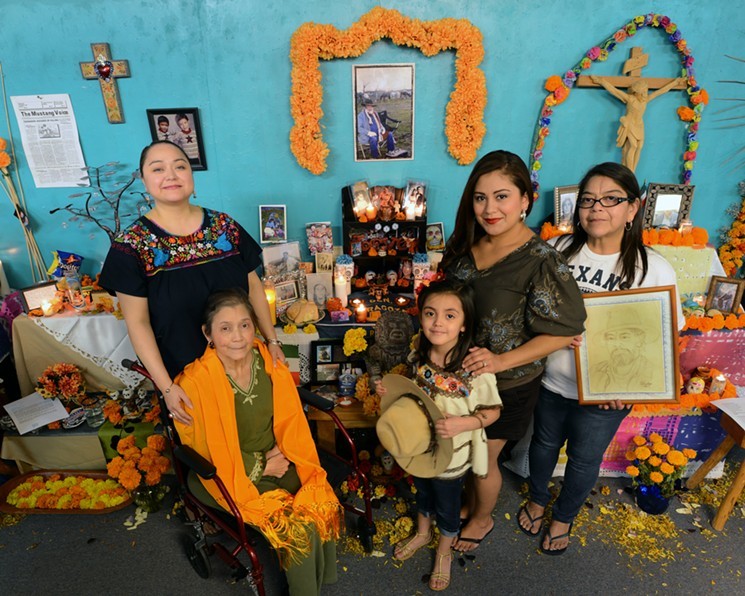 The Vasquez family remembers and honors their loved one with an ofrenda containing photographs, letters and prized possessions.