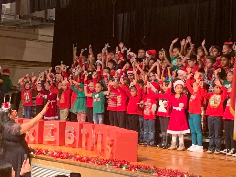 Abby Veliz leads her Garfield Elementary students in song at a holiday program in December 2019.