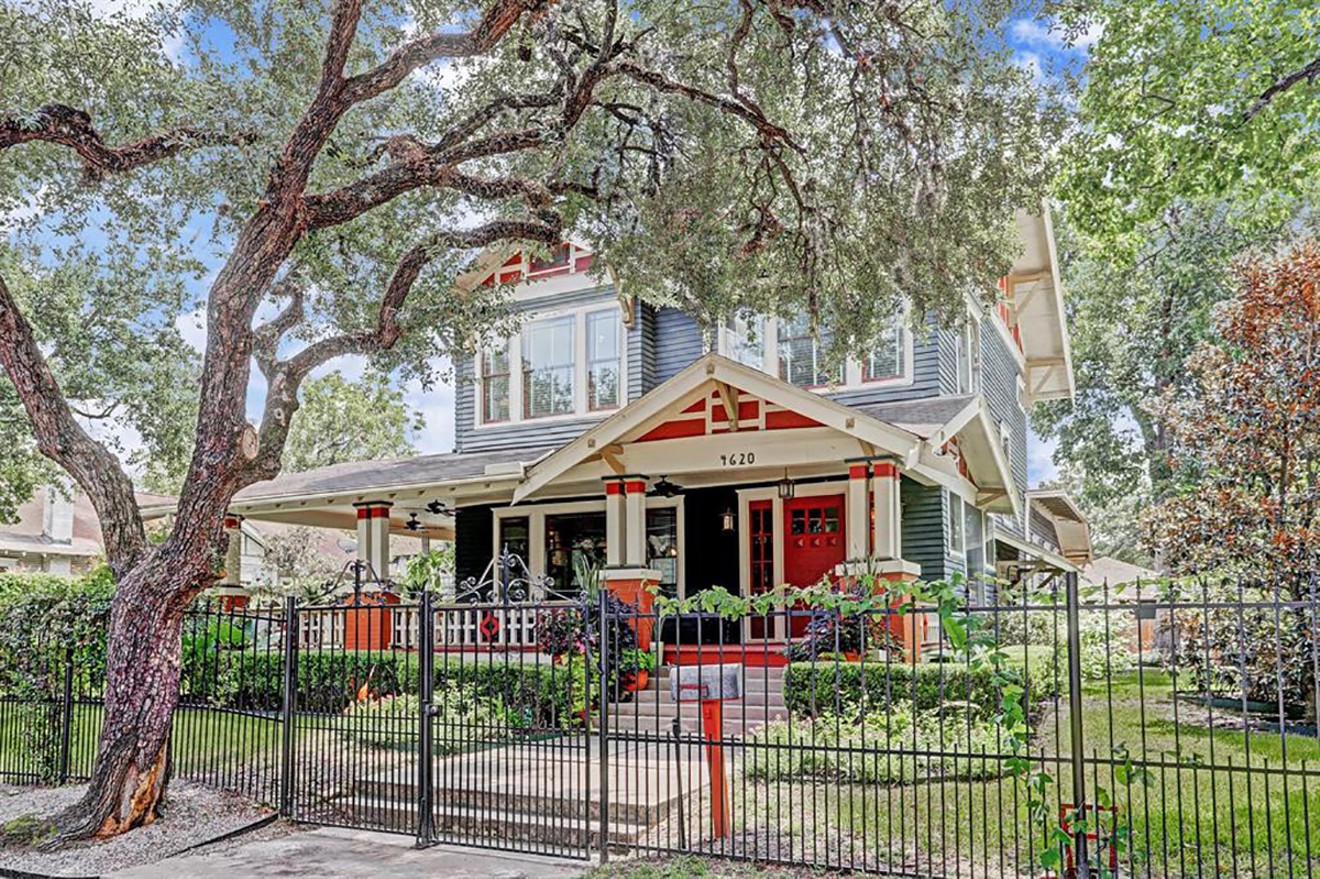 The centennial Arts and Crafts home at 4620 McKinney is surrounded by live oaks and was one of the first three homes built in historic Eastwood.