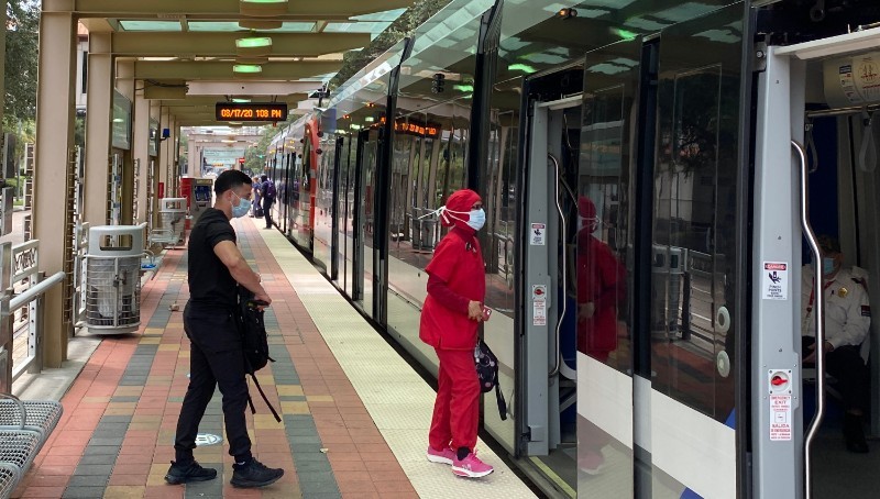 METRO passengers board the light rail in the Medical Center with face masks on, which METRO has required since June 25.
