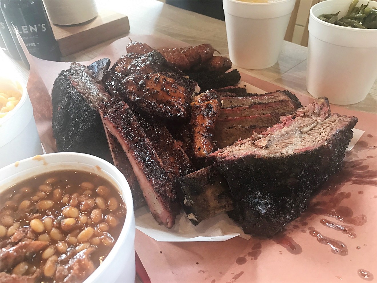 An epic meat tray at Killen's Barbecue with brontosaurus-sized beef ribs, fatty and lean brisket, pork ribs, sausage and chicken.