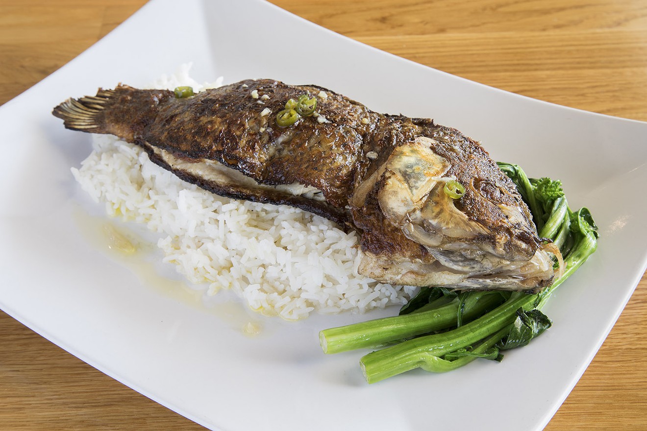 The lemongrass tilapia arrived skin on, filleted, boneless and head-on with a bed of jasmine rice and sautéed greens.