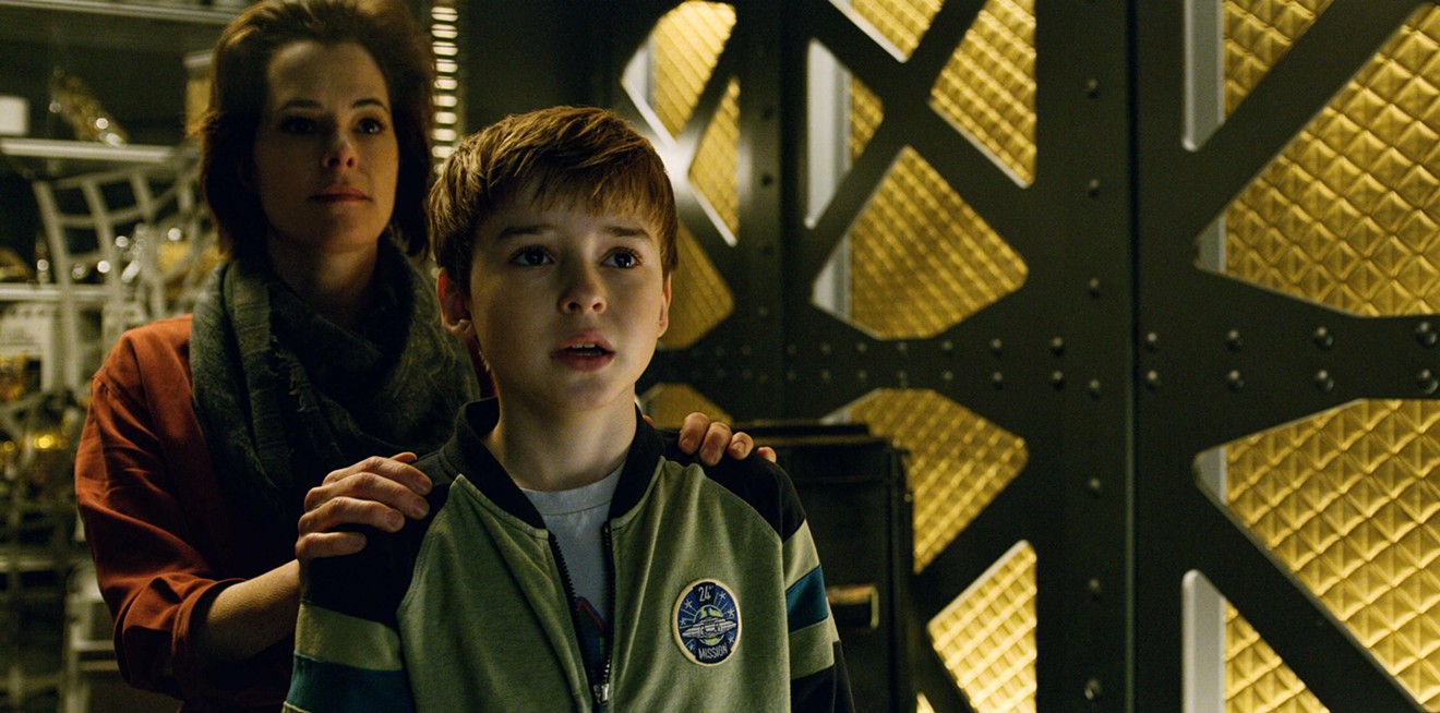 Maxwell Jenkins (right) plays Will Robinson, one of the three children in a family Lost in Space, where Dr. Smith, the conniving, bitter and self-serving villain, is portrayed in this Netflix series by Parker Posey.