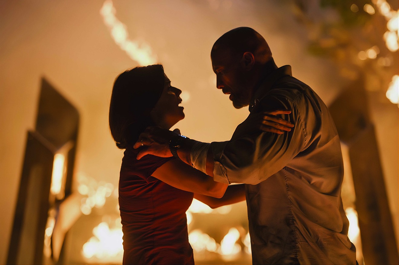 Dwayne Johnson (right) and Neve Campbell team up as husband-and-wife characters who take on the bad guys in Rawson Marshall Thurber’s Skyscraper, a film rated PG-13 that features dead-serious suicide bombers.