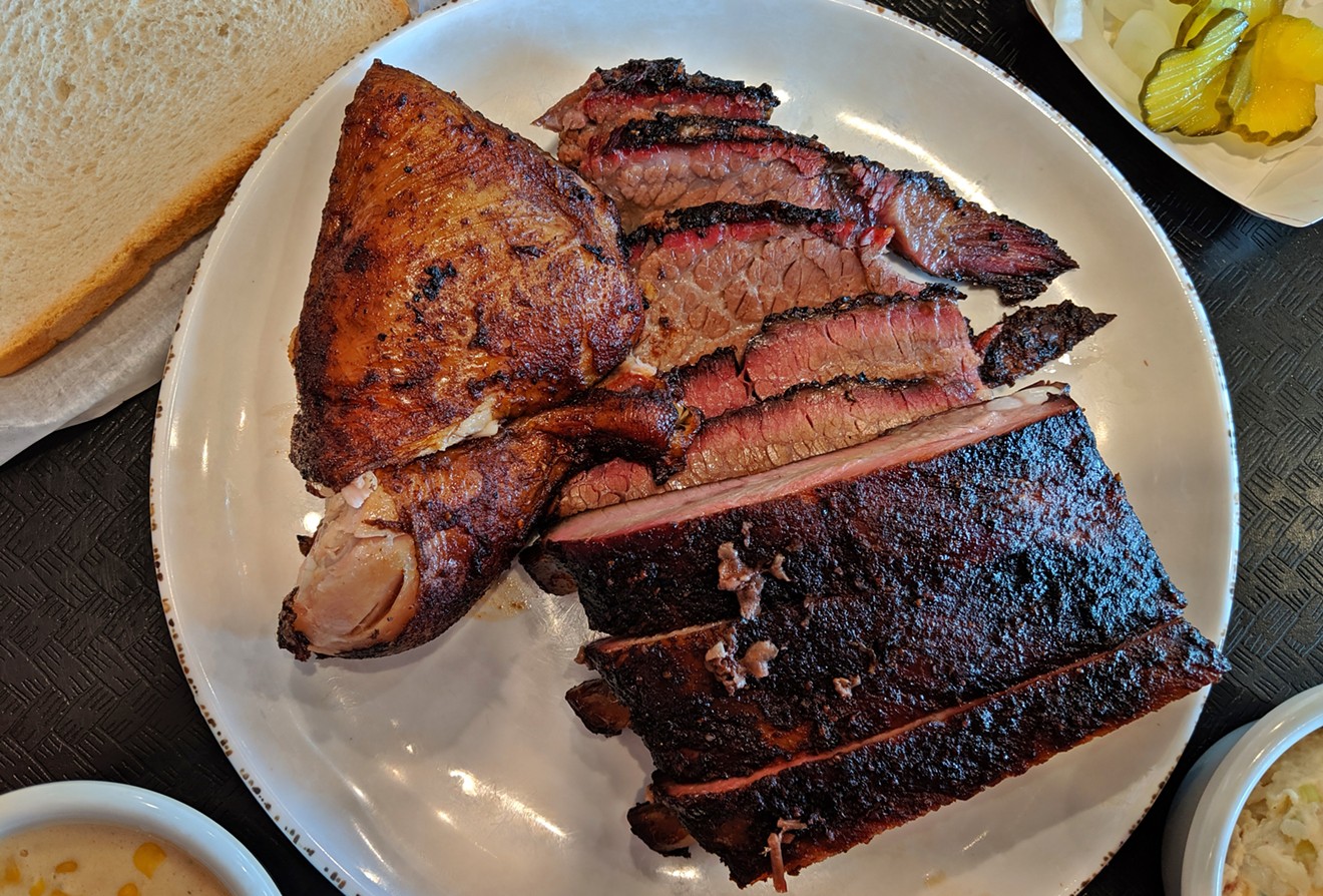 Three-meat platter with brisket, pork ribs and chicken.