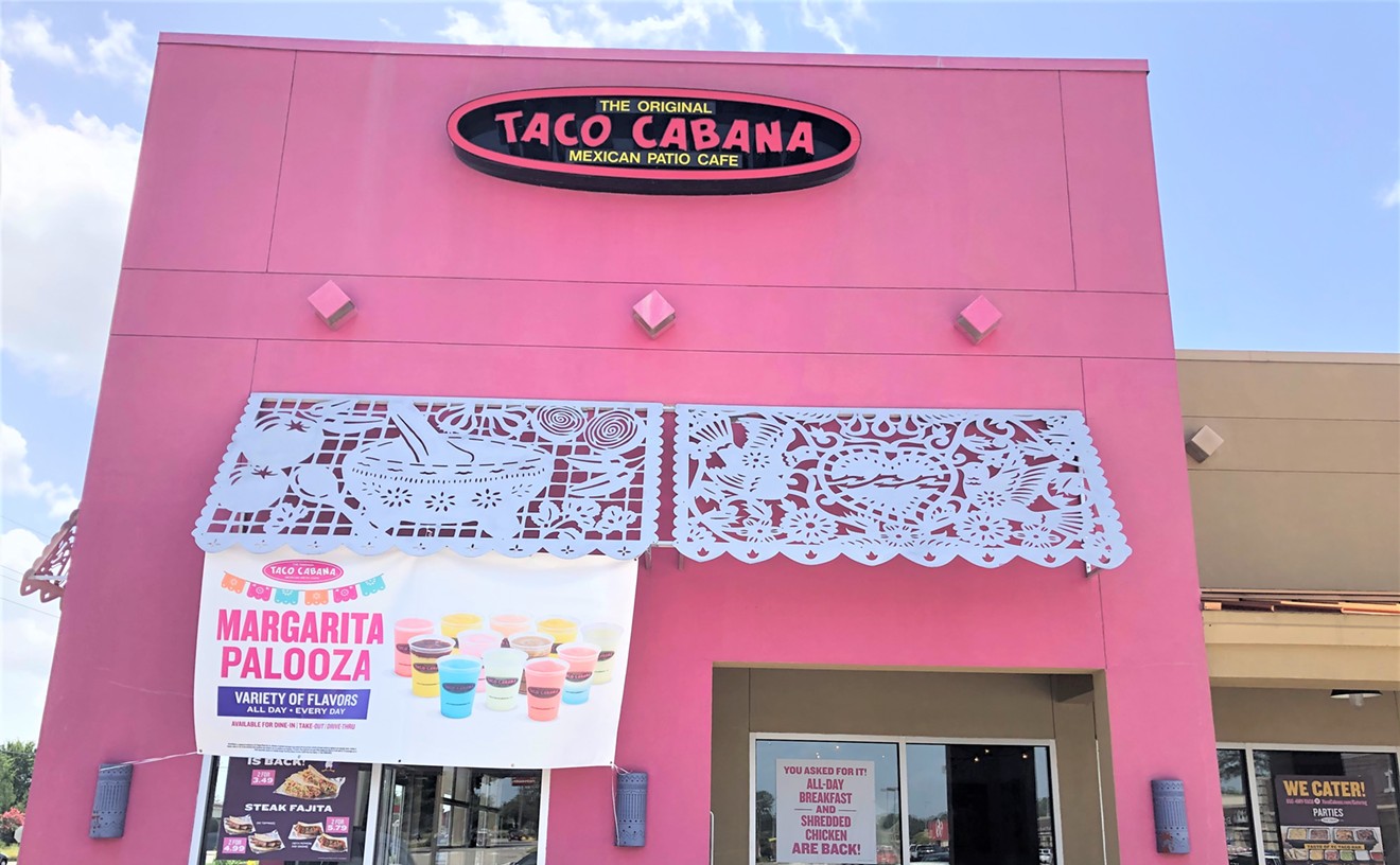 The bright pink exterior of Taco Cabana.