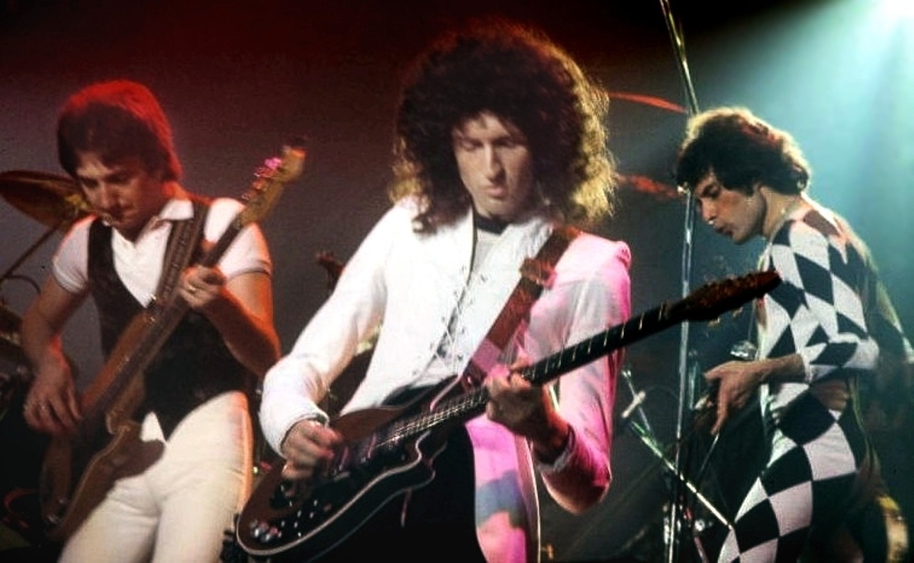 John Deacon, Brian May, and Freddie Mercury of Queen onstage in 1977.