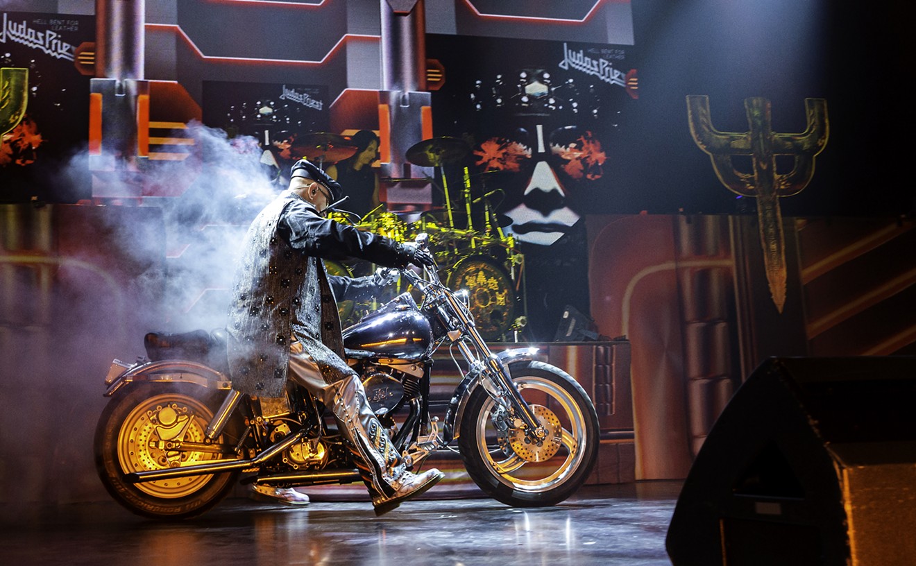 Rob Halford's trademark entry is roaring onstage astride a Harley.