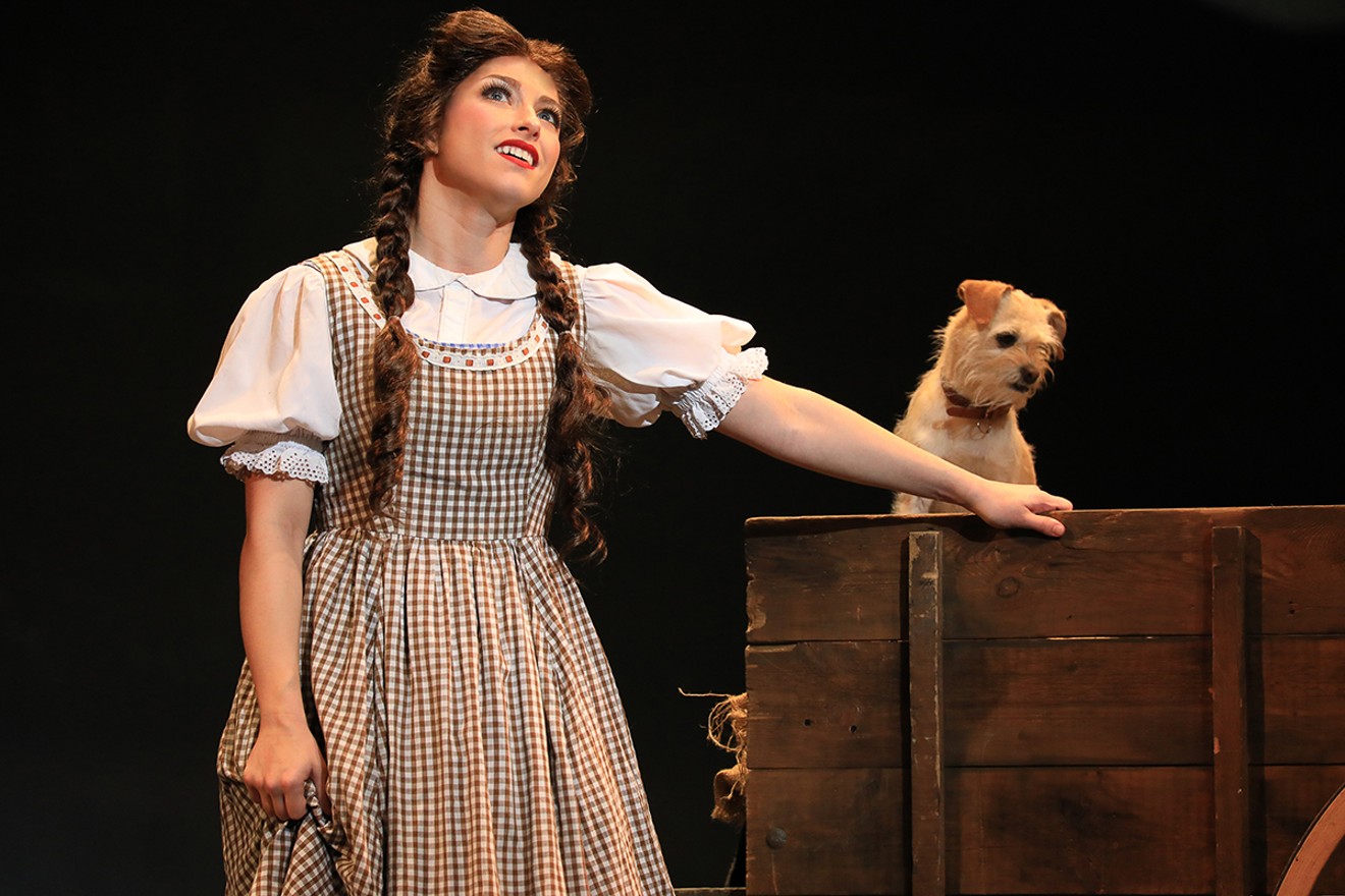 Dorothy (Kalie Kaimann) sings "Over the Rainbow" while Toto (Murphy) waits for his next trick.