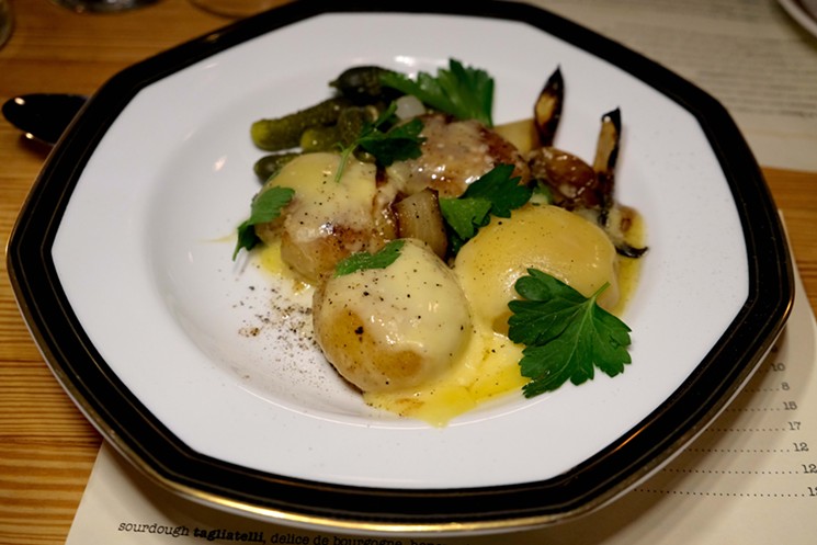 Raclette served over confited yukon gold potatoes. - PHOTO BY MAI PHAM