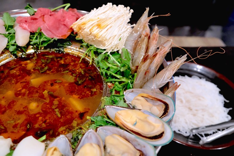 Seafood and enoki mushrooms are some of the features in this Thai hot pot. - PHOTO BY MAI PHAM