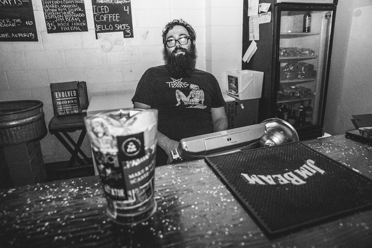 Zack Palmer, owner of Walter's behind the bar for one of the last times. - PHOTO BY DEREK RATHBUN