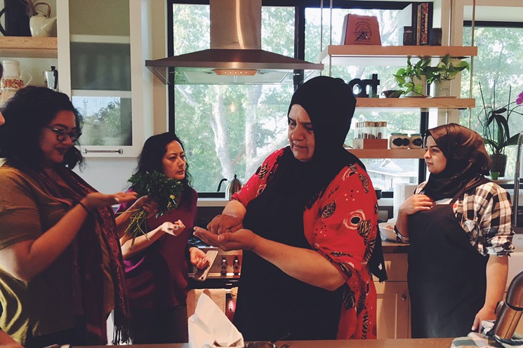 Wafdiya (center) and her daughter Zainab (right) taught my friends and me how to cook food from their homeland. - PHOTO BY ERIKA KWEE
