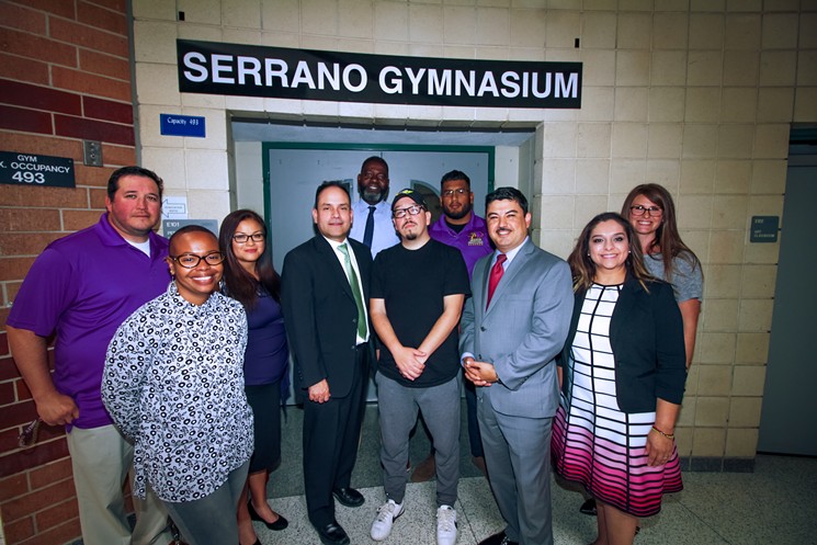 Stevenson Middle School faculty and staff join Steven "Shea" Serrano for a photo after the school gym was renamed "Serrano Gymnasium" in his honor. - PHOTO BY MARCO TORRES