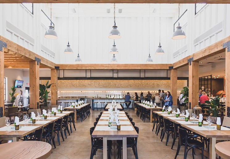 Communal tables add to the wine country feel at Sixty Vines. - PHOTO COURTESY OF SIXTY VINES