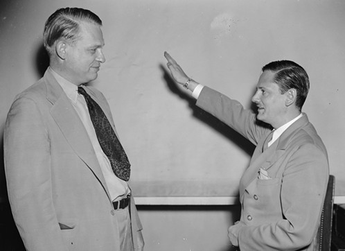 U.S. House Rep. from Texas Martin Dies meets with former journalist John C. Metcalfe (right). Metcalfe infiltrated the Bund and testified to what he experienced in front of a Congressional committee. Here he shows Dies the Nazi salute on August 12, 1938. - HARRIS & EWING COLLECTION: LIBRARY OF CONGRESS/COURTESY OF THOMAS DUNNE BOOKS