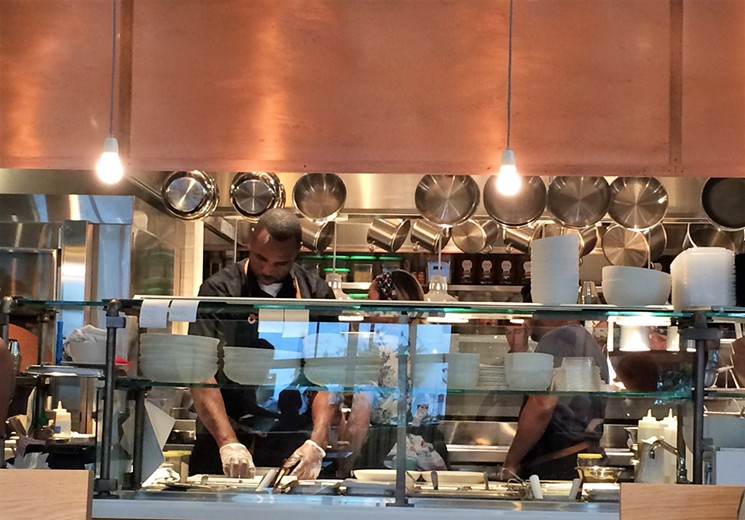 The kitchen is hopping at Flower Child. - PHOTO BY LORRETTA RUGGIERO