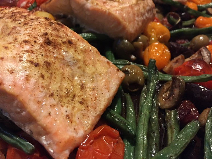 Roasted green beans, olives, tomatoes and grapes with ras el hanout, topped with salmon and roasted again. - PHOTO BY NICHOLAS L. HALL