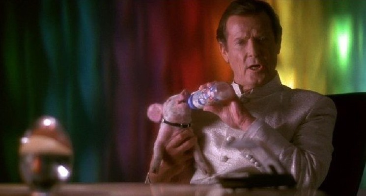 Nothing to see here, just Sir Roger Moore nursing a piglet. - COLUMBIA PICTURES