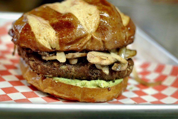 The vegan burger at New Spot Eatery on a pretzel bun. - PHOTO BY SEAN SHAH