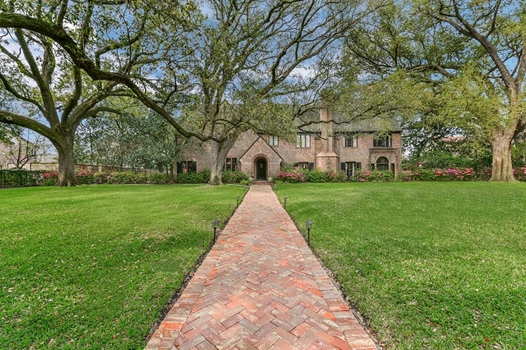 The deed restrictions in Broadacres call for all buildings to be residential, to be set back 60 feet from the street, and to be uniform in their orientation. Notice the recent addition of a custom chevron brick walkway at this new listing. - PHOTO BY PROHOUSE PHOTOS