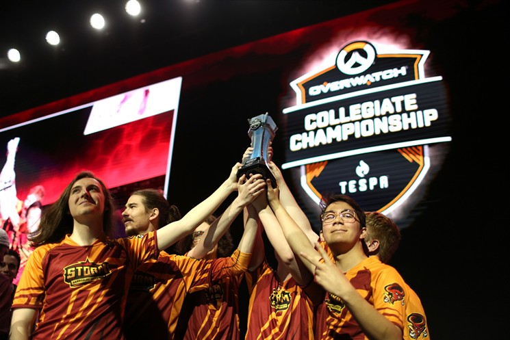 Harrisburg University lifts the trophy after winning the Overwatch championship. - PHOTO BY GABRIEL CHRISTUS / ESPN IMAGES