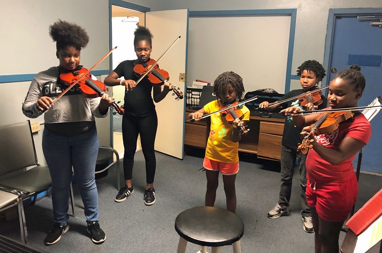 A group of pre-teen violin students work their way through a classical piece. - PHOTO BY BOB RUGGIERO