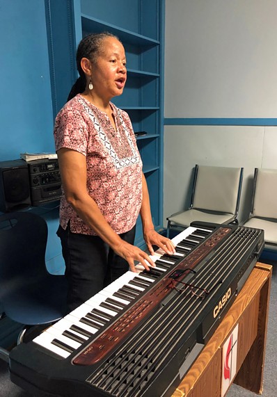 Dr. Anne Lundy behind her Casio keyboard. - PHOTO BY BOB RUGGIERO