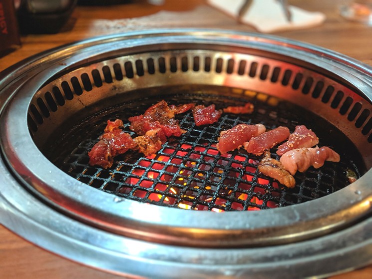 Beef and pork belly on the grill at Gyu-Kaku - PHOTO BY CARLOS BRANDON