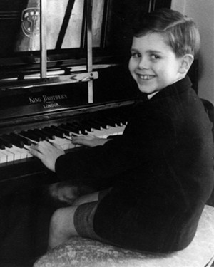 A young Elton John at the piano, dreaming of Little Richard and Jerry Lee Lewis. - THE ELTON JOHN FAMILY COLLECTION