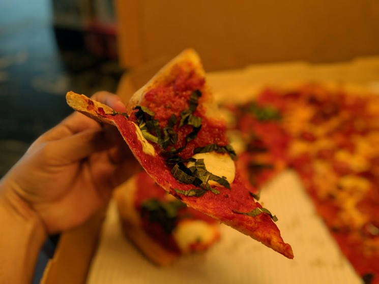 Sauce-forward pizza with an extremely crispy locally-sourced crust. - PHOTO BY CARLOS BRANDON