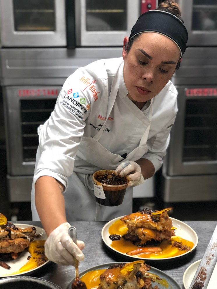 Chef Ariel Fox puts the finishing touches on her Pollo en Cacahuate. - PHOTO BY CHRISTA CASSATA
