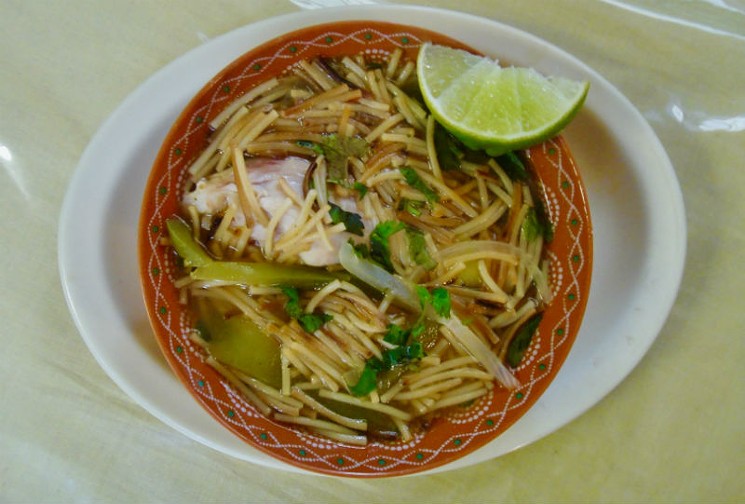 Fideo is an iconic dish of Texas Mexican cooking, pan roasted vermicelli in a seasoned tomato broth. Doña María adds a slice of poached chicken breast. - PHOTO BY ADÁN MEDRANO