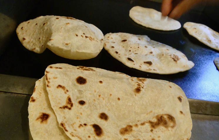 Traditional Texas Mexican tortillas puff up on the griddle. Master tortilla maker, Griselda Delgado Ochoa, flips them effortlessly, lightly. - PHOTO BY ADÁN MEDRANO