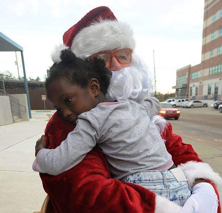 After visiting incarcerated parents, children will receive gifts, smiles and hugs. - PHOTO BY DAVID ATWOOD