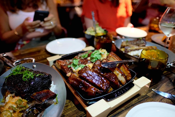 A signature dish on the International Smoke menu? This trio of smoked, St. Louis style pork ribs. - PHOTO BY MAI PHAM